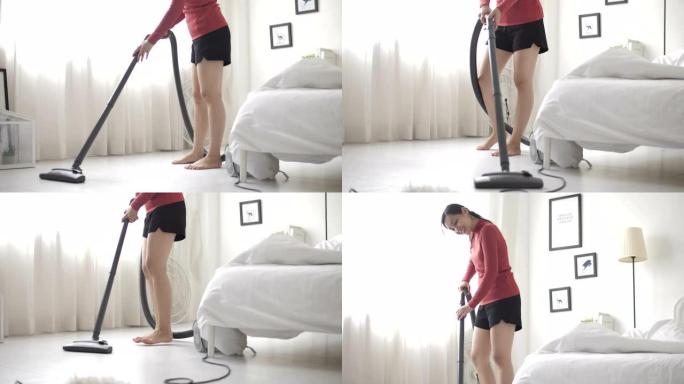 家庭主妇用吸尘器打扫房间