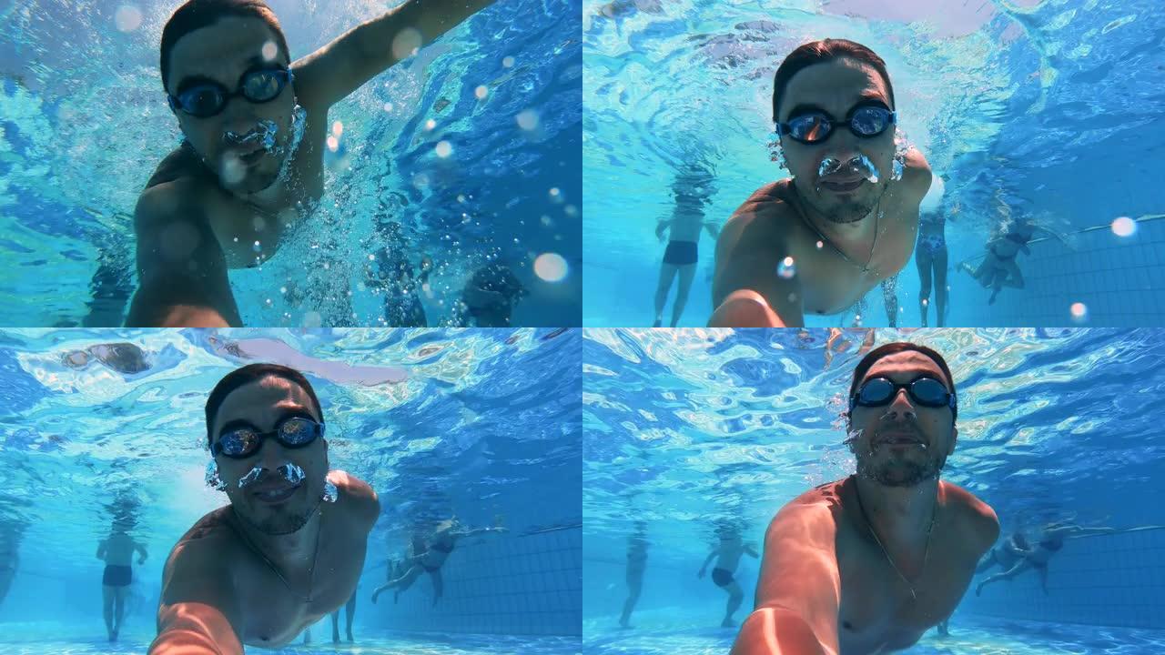 一个拿着相机的男人正在潜水和拍摄自己