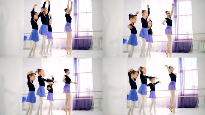 女孩在芭蕾舞课上与老师一起训练，特写镜头。