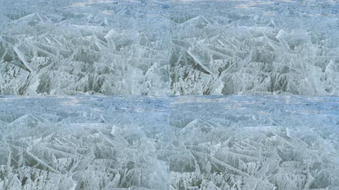 特写: 裂缝和气泡在厚厚的冰层下创造出美丽的图案