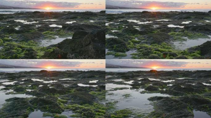 日落天空反射在岩石海洋海岸游泳池。特内里费岛希达尔戈角附近的海滩。万向节射击，4K