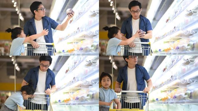 一名亚裔华裔父女在杂货店购物冰箱蔬菜部挑选买菜