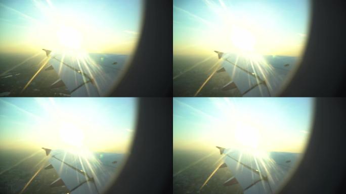 飞机机翼从飞机窗口起飞的日落飞行