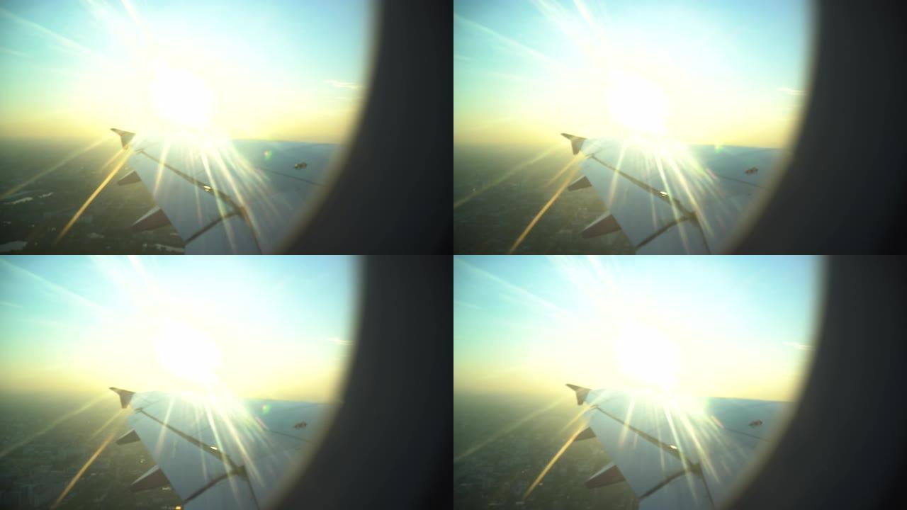 飞机机翼从飞机窗口起飞的日落飞行