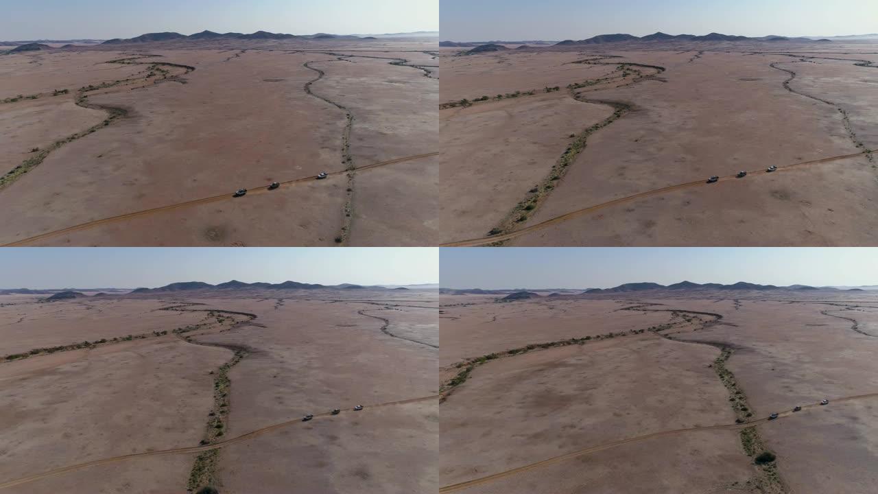 4x4车辆驶过纳米比亚纳米布沙漠的4k高空中平移视图