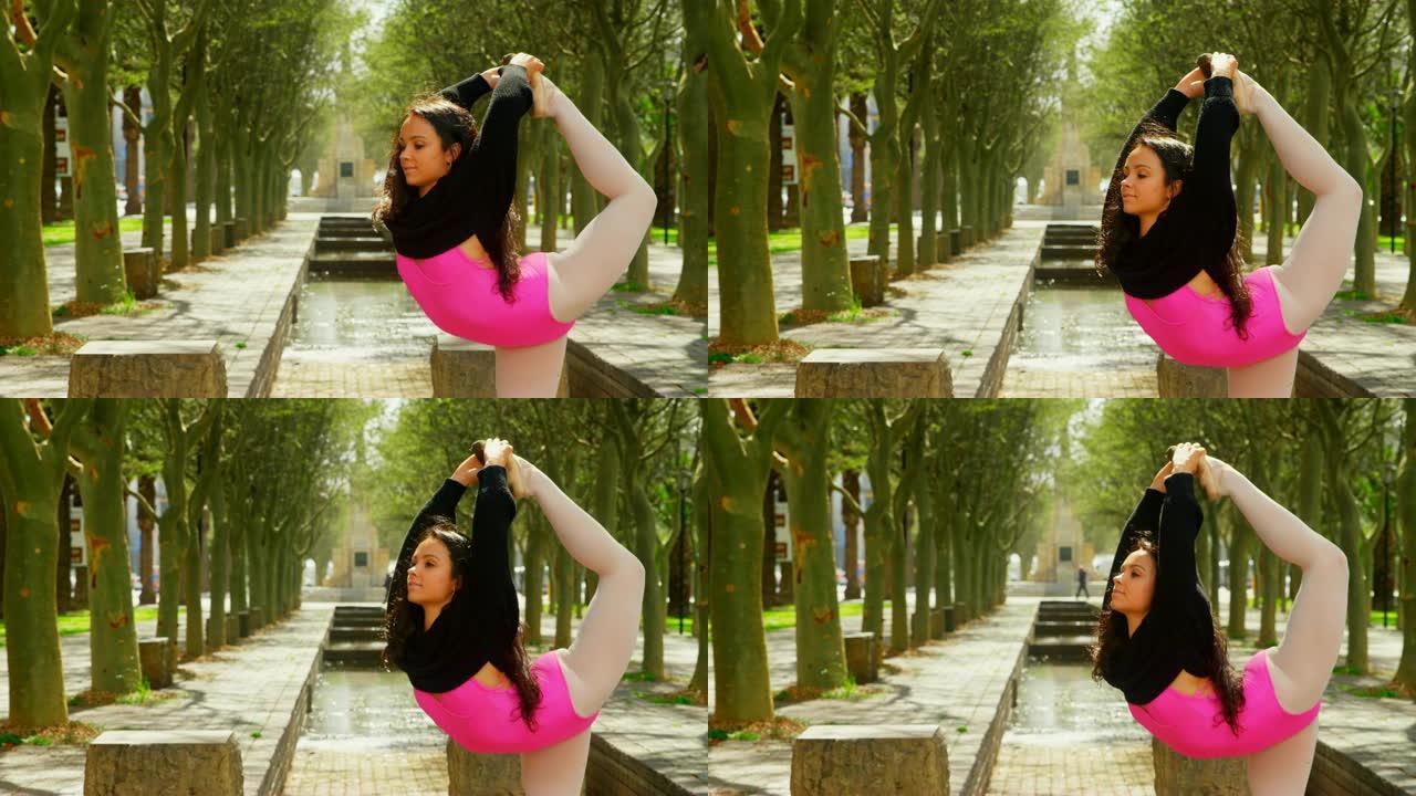 年轻的芭蕾舞女演员在公园4k跳舞时伸腿