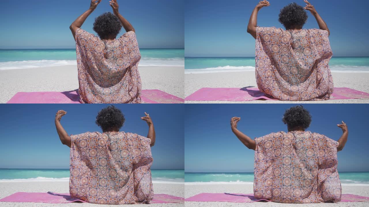 在海滩上做瑜伽的高级女性