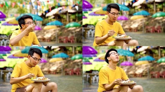 亚洲男子放松饮食垫Kra Pao，最受欢迎的泰国菜之一，罗勒辣猪肉米饭
