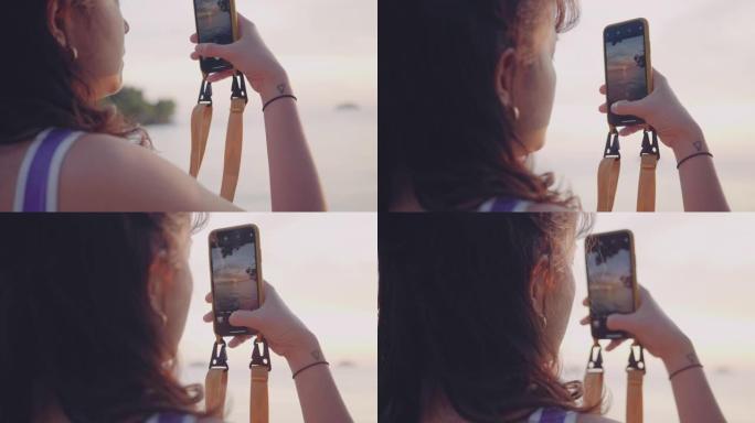 年轻女子在海滩上使用手机