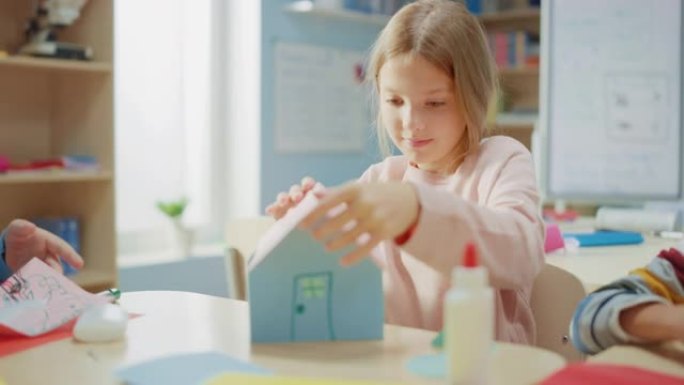 小学工艺品班: 各种各样的聪明孩子在手工艺品项目上玩得开心，用五颜六色的纸、剪刀和胶水建造纸制房子。