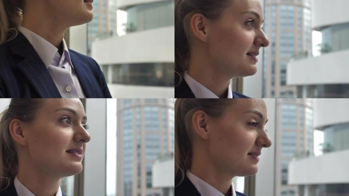 美丽的女人首席执行官在她的办公室看着窗外，成功的信心