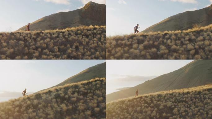 日落时在山脊上奔跑的年轻活跃男子