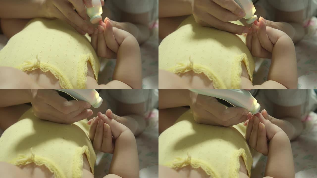 母亲在家里给婴儿剪指甲的特写镜头