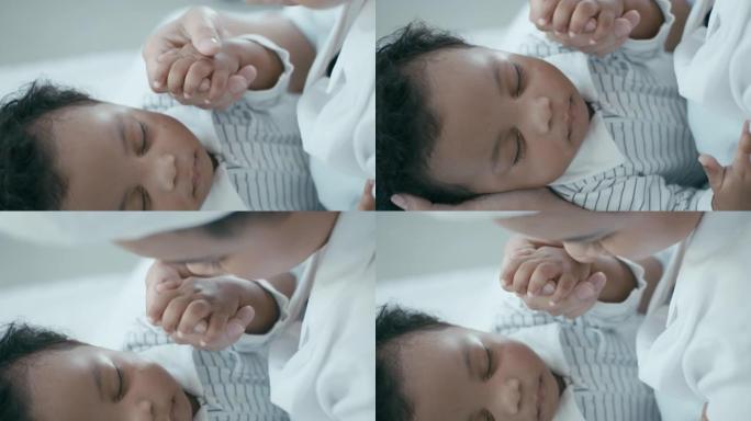 妈妈握着和亲吻宝宝的手的特写镜头，慢动作