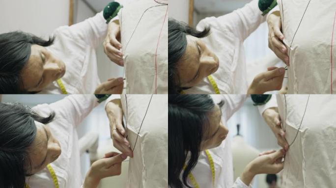 中国设计师男士为裁缝模型装配缝纫图案的侧视图