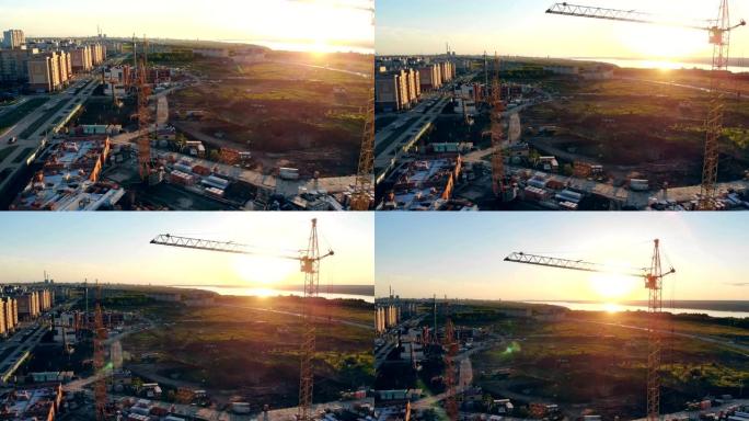 日落在充满机器和设备的项目现场。建筑面积、场地面积从上面看。