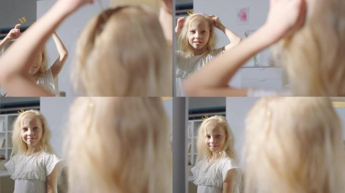 可爱的小女孩看着镜子，戴上皇冠发带