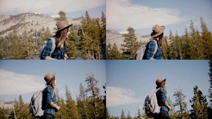 年轻漂亮的旅游女孩，背着背包和相机独自在优胜美地国家公园山湖徒步旅行。