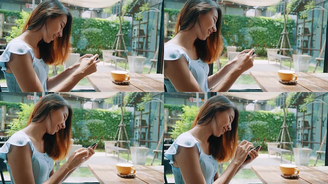 女性博客作者用手机在咖啡馆里拍摄咖啡杯。一名年轻女子在智能手机上拍摄咖啡茶的照片，用移动相机拍摄餐点
