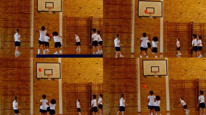 小学生在4k学校篮球场练习篮球