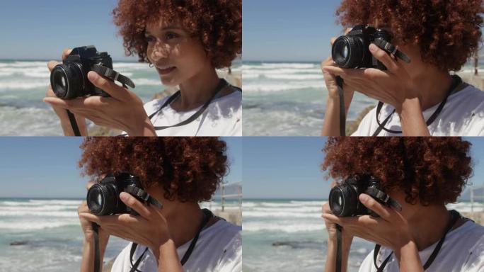 女人在海滩上用数码相机拍照4k