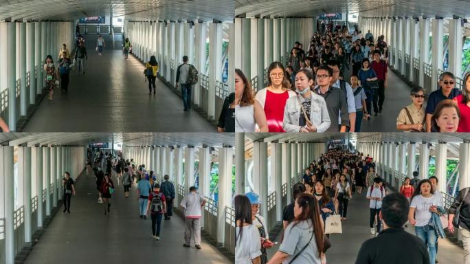曼谷BTS Chong Nonsi高峰时段，拥挤的匿名人群在高架地铁系统站的立交桥上行走，交通和乘客