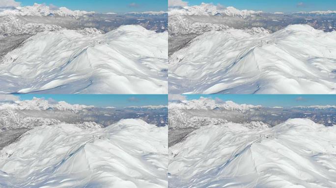空中: 飞向壮观的阿尔卑斯山滑雪胜地的山坡。