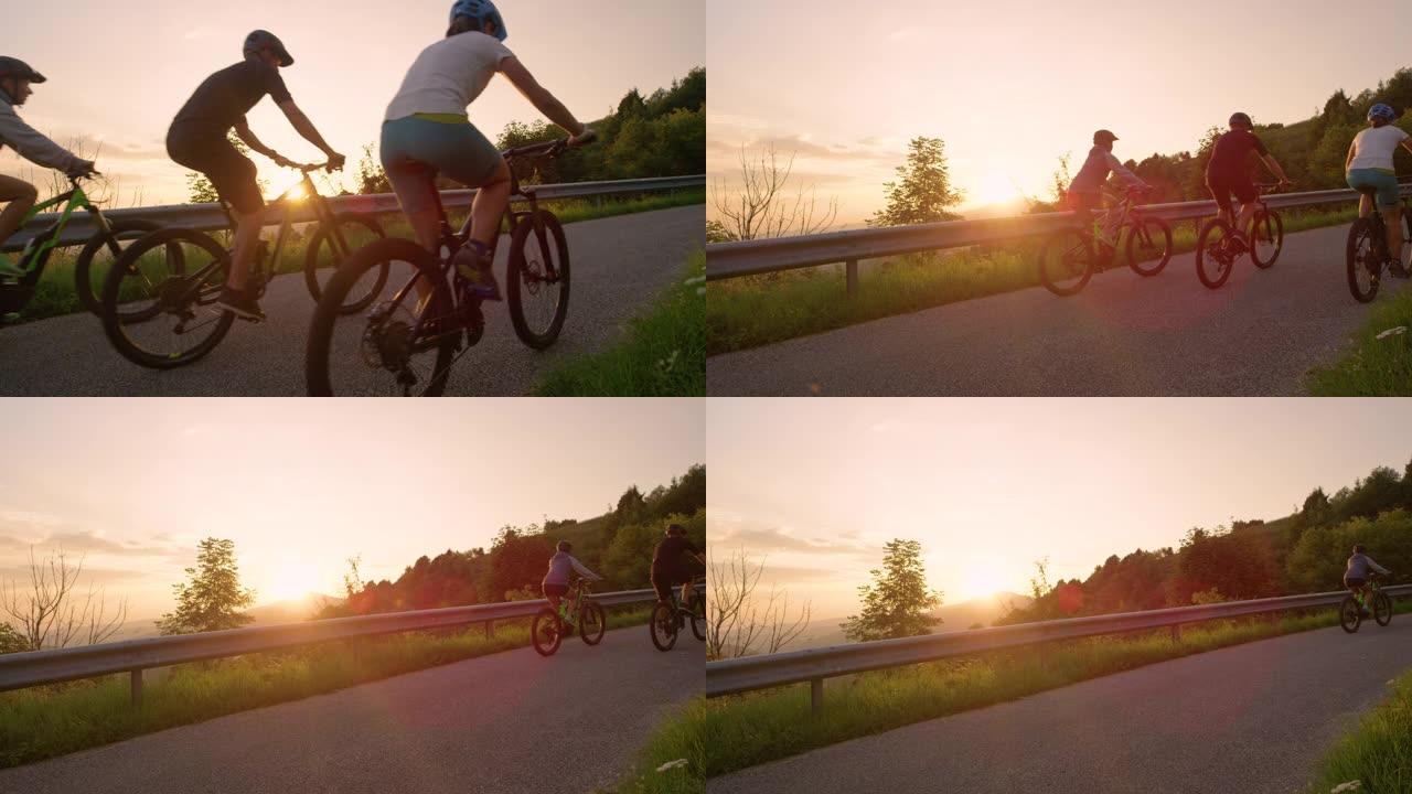 特写: 一群骑自行车的人在日落时沿着空旷的乡间小路骑自行车。