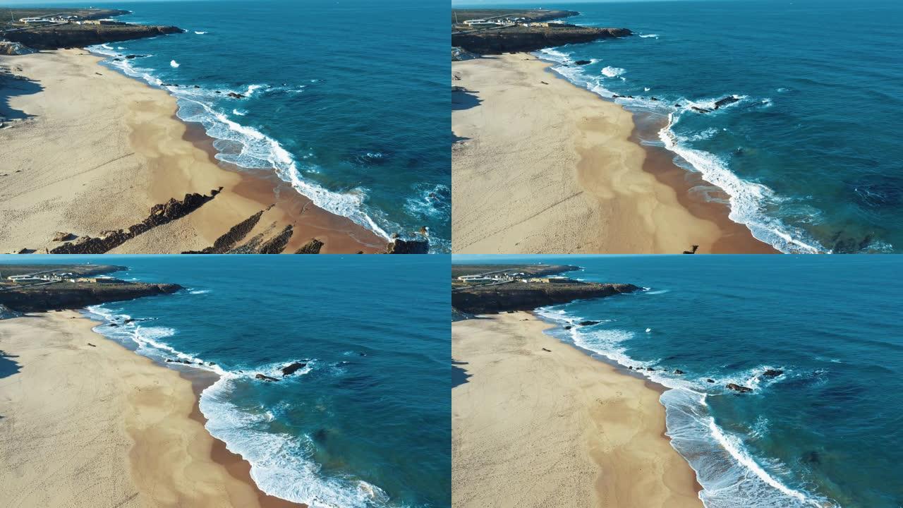 空中无人机镜头: 葡萄牙岩石海岸，海景优美。飞越葡萄牙，海岸线上碧绿的海浪在沙滩上滚动。Praia 