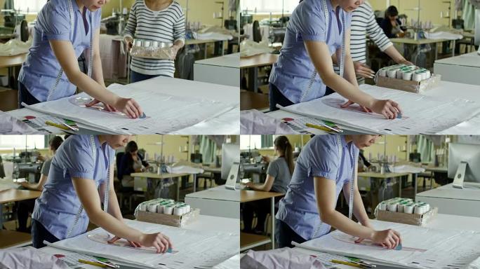 女人在织物上画线慢动作慢镜头工匠大师制衣