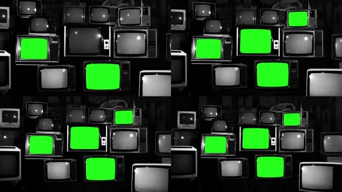 许多带有绿色屏幕的电视。黑白色调。