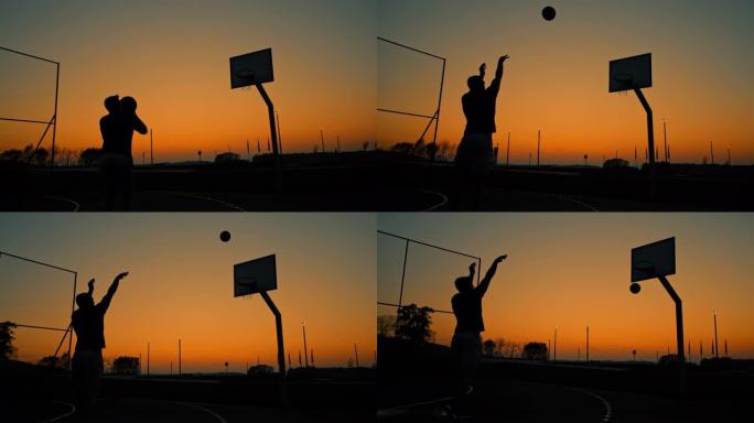 MS超级慢动作剪影年轻人在黄昏时在室外篮球场上射击篮筐
