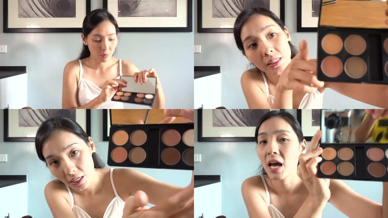 年轻的亚洲女性在她的视频博客上制作化妆教程