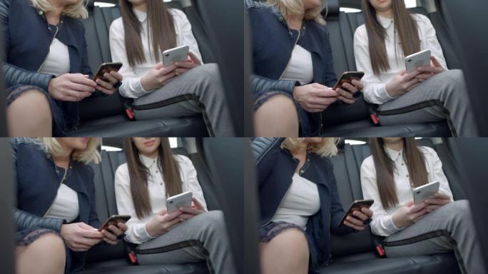 女士在众包出租车的后座上使用智能手机的年轻女性