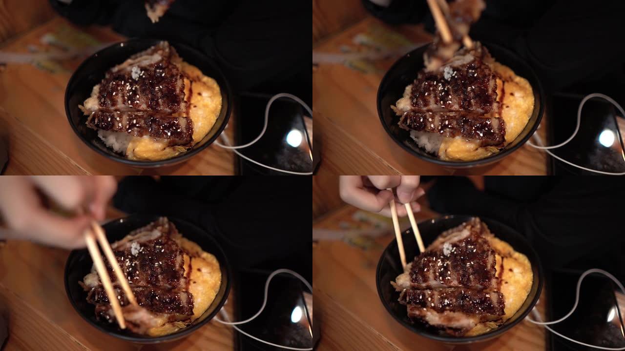 旅行者在日本餐厅吃炸猪饭的特写镜头