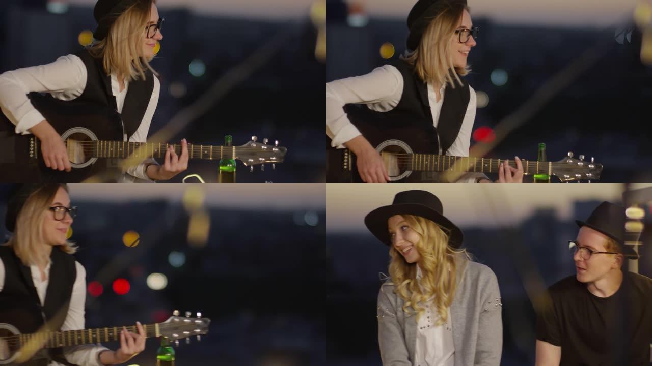 女人在夜间屋顶派对上弹吉他和唱歌给朋友