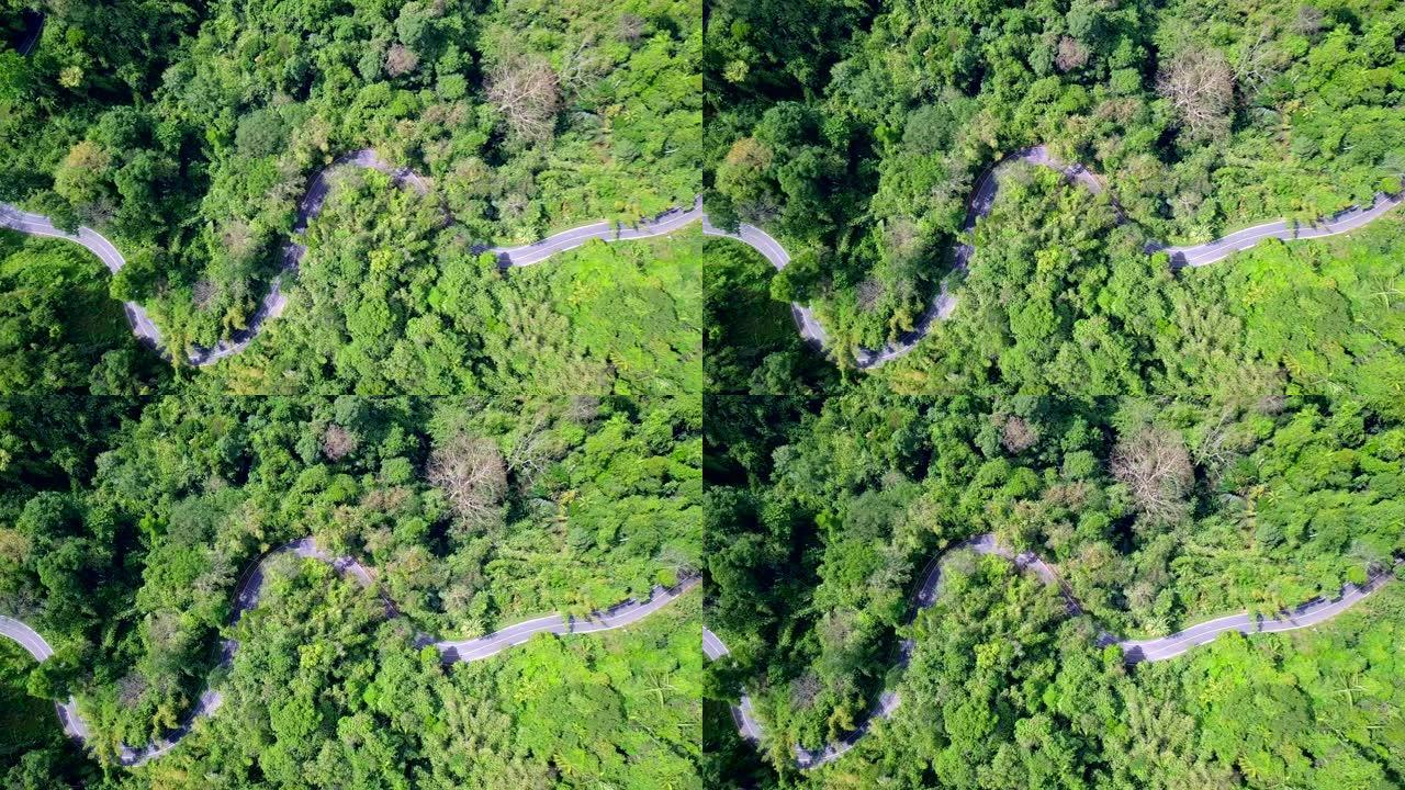 顶视图森林和山脉中的路，穿越泰国森林的公路旅行