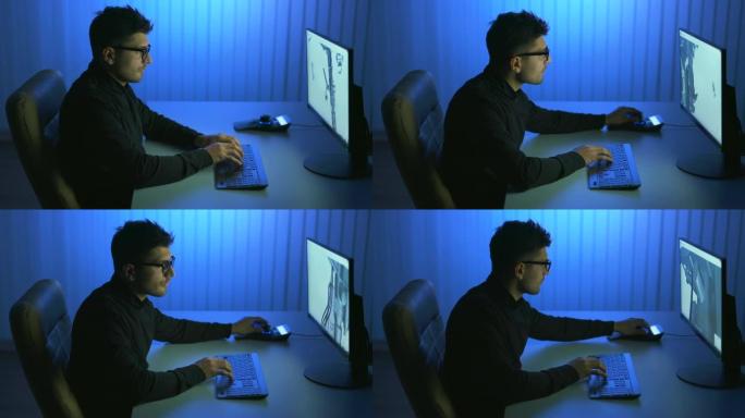 该人在计算机中使用3d机械手工作。晚上时间