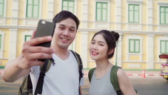 亚洲博主夫妇在泰国曼谷旅行，甜蜜的夫妇使用手机制作vlog并在社交媒体上生活，同时在假日旅行中度过甜