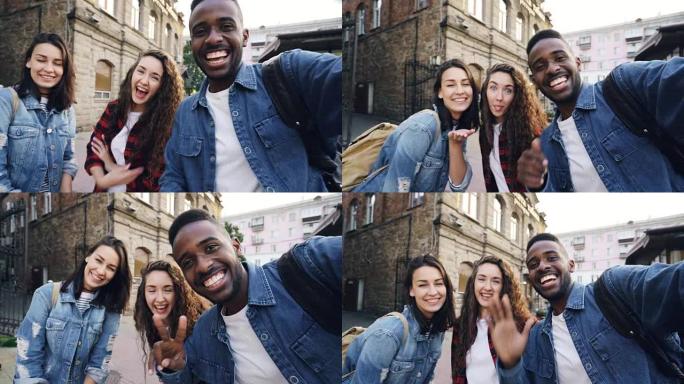 有吸引力的年轻男女旅行者在街上拍照拍照，拿着相机大笑。现代技术和旅行理念。