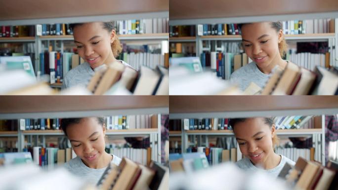 美丽的非裔美国少女在大学图书馆选书