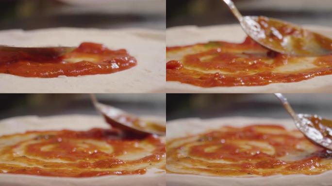 靠近披萨厨师的手揉捏面团，准备美味的披萨，然后撒上番茄酱。