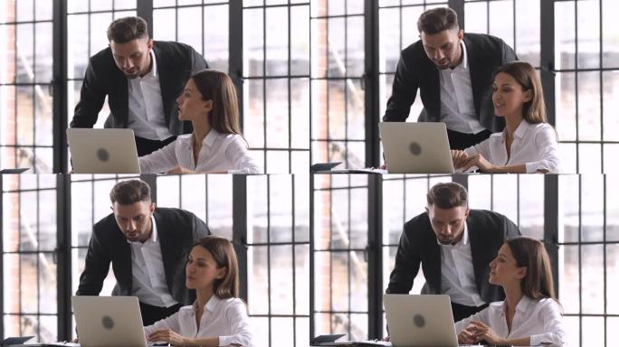 男老板帮助女员工在办公室进行在线任务