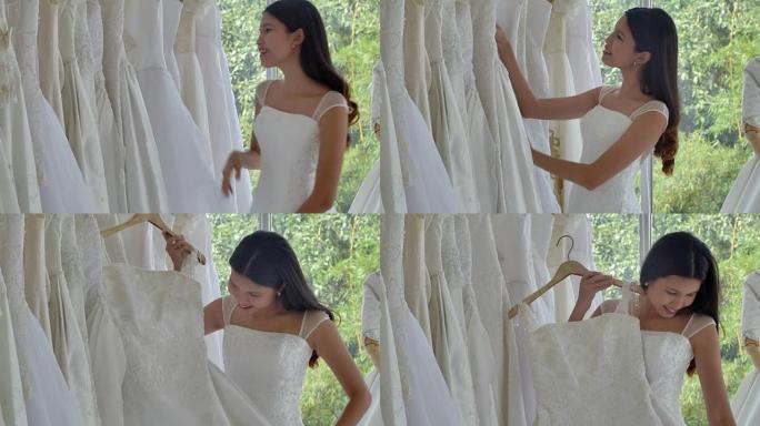 女性在婚礼时装店穿婚纱时玩得开心，生活方式: 里程碑和庆祝概念