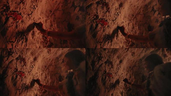 原始的史前尼安德特人的孩子穿着动物皮在晚上在墙上画动物和摘要。用岩画创造第一个洞穴艺术，用火照亮的岩