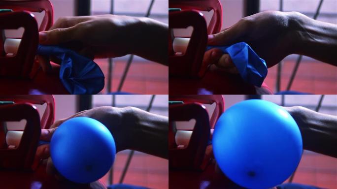 男性的手用氦气给气球充气。