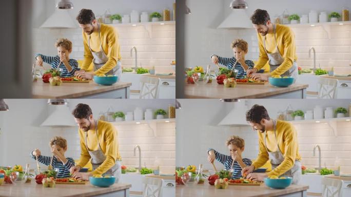 在厨房: 父亲和可爱的小男孩一起烹饪健康晚餐。爸爸教小儿子健康的习惯，以及如何在沙拉碗中混合蔬菜。可