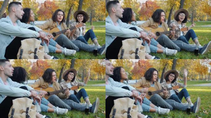 快乐的青春唱歌在公园外面拿着酒瓶弹吉他