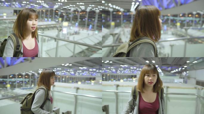 年轻的亚洲背包客女游客在国际机场散步。