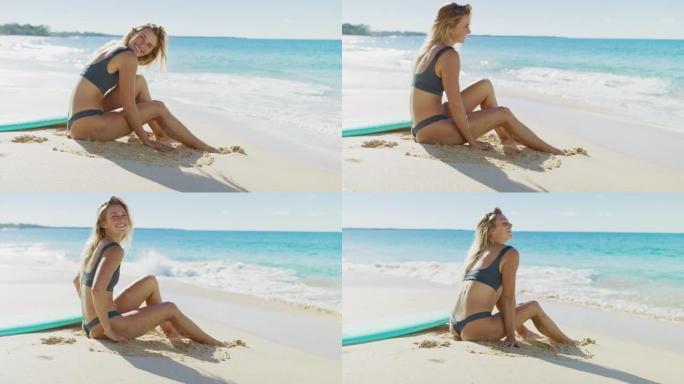 快乐健康的冲浪女人坐在沙滩上